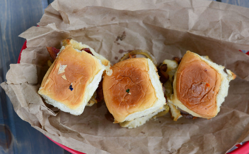 Hatch Green Chile Sliders: sweet Hawaiian roll, with a mini hamburger patty, roasted Hatch Green Chilies, sweet sautéed onions, crisp bacon, and cheese. 