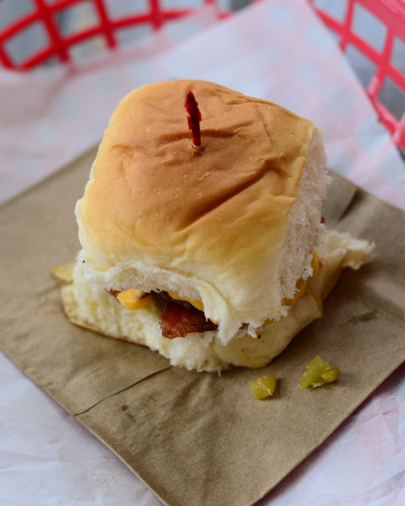 Hatch Green Chile Sliders: sweet Hawaiian roll, with a mini hamburger patty, roasted Hatch Green Chilies, sweet sautéed onions, crisp bacon, and cheese. 