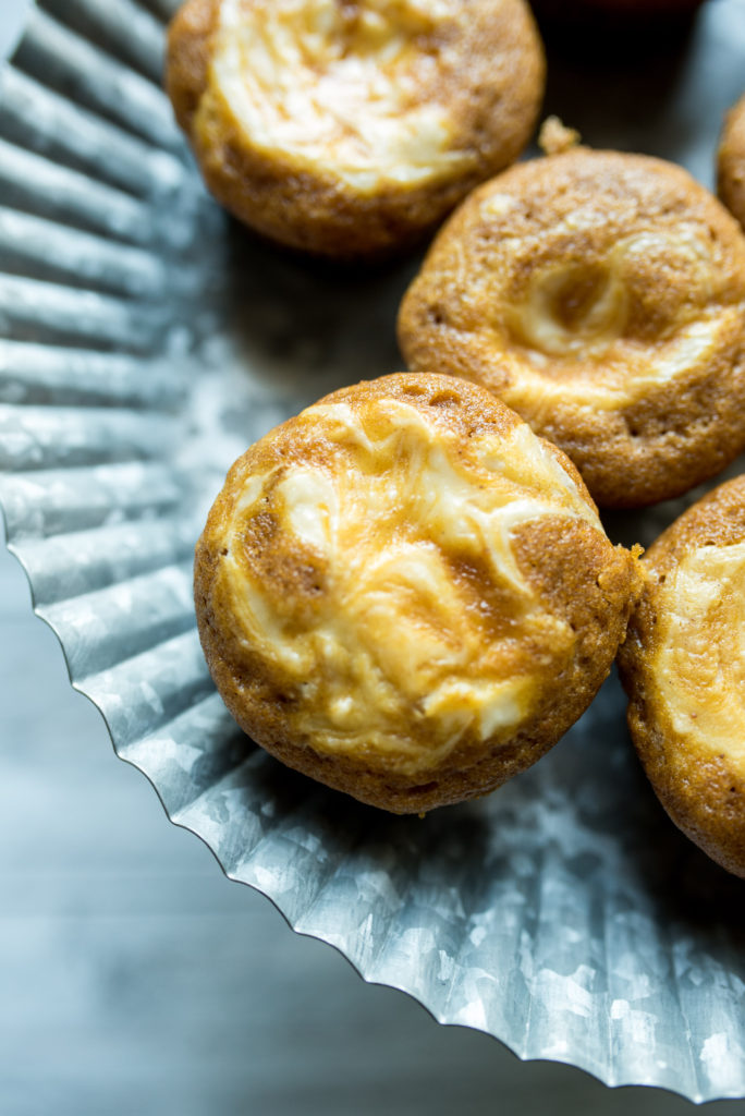 Pumpkin Cream Cheese Muffins: warm cinnamon and nutmeg, rich cream cheese swirled on top, + the ultimate taste of fall-- pumpkin! Similar to Starbucks Original.