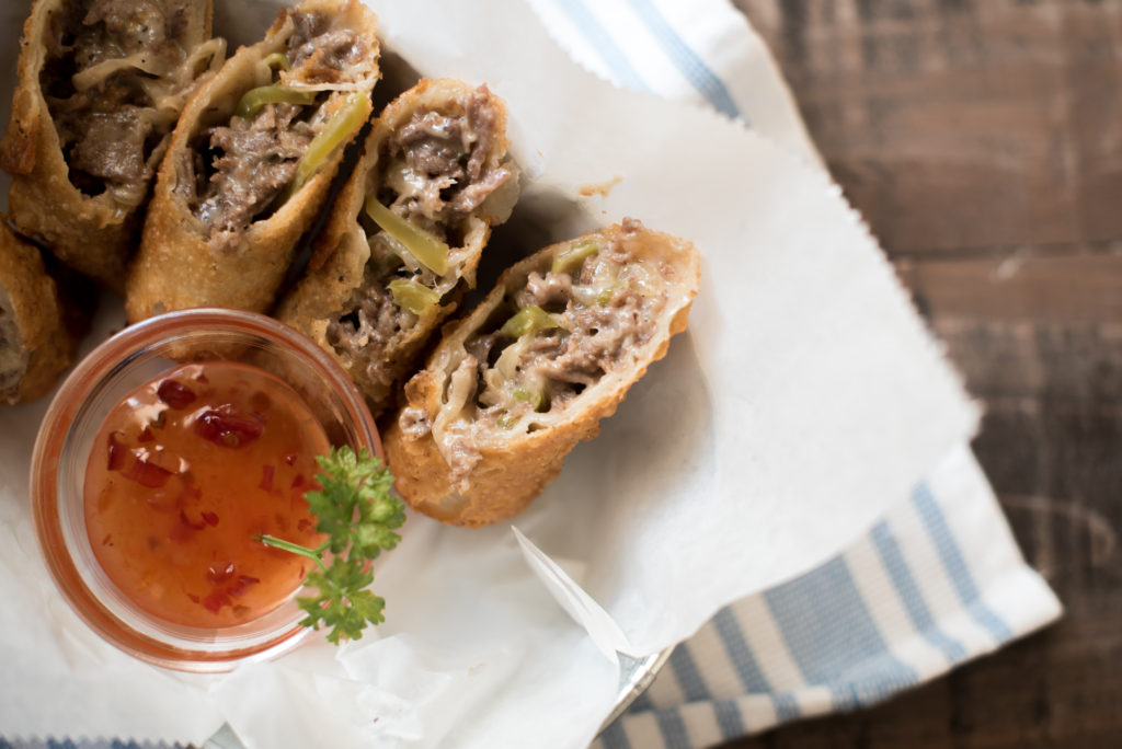 Philly Cheesesteak Egg Rolls with thinly sliced steak, seasoned peppers and onions, and creamy cheese sauce. Famed Del Frisco's Grille CopyCat recipe.