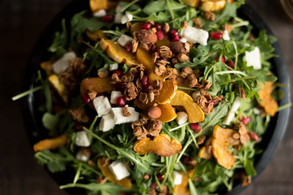 Delicious Fall Inspired Salad: Roasted Delicata Maple Salad with roasted squash, pomegranate, feta, granola, and a delicious apple cider vinaigrette. 