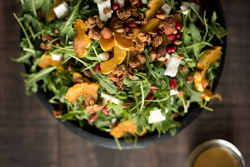 Delicious Fall Inspired Salad: Roasted Delicata Maple Salad with roasted squash, pomegranate, feta, granola, and a delicious apple cider vinaigrette. 