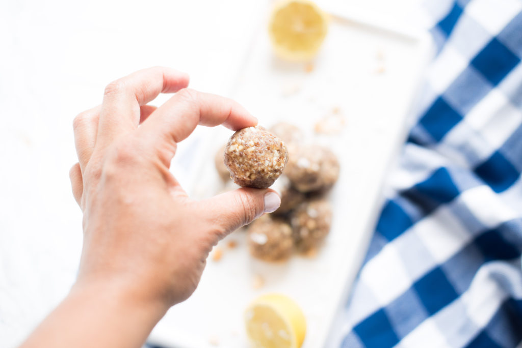 The perfect portable snack: Lemon Cookie Bliss Balls sweetened with dates and made with the perfect combination of nuts and coconut flakes.