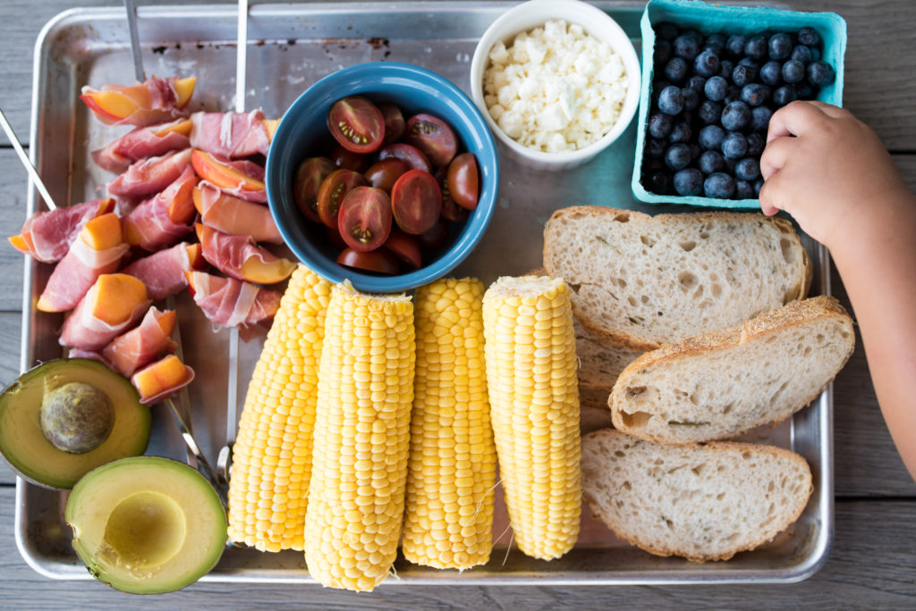 This Grilled Prosciutto wrapped peach panzanella salad is a light and delicious summer salad with grilled prosciutto-wrapped peaches, sweet blueberries, crumbled feta, grilled sourdough and charred corn.